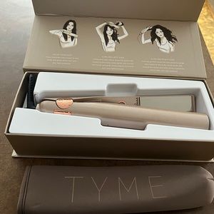 Tyme curling iron. Brand New in opened box. Comes with cooling carrying bag.
